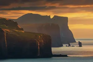 Coast Line Prints: The coastline view from the Kallur Lighthouse over the northern cliffs towards the sea stacks of Risin og Kellingin