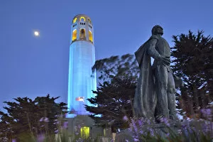 Coit tower and Christopher Columbus statue at night, San Francisco, USA