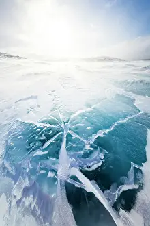 Sunlight Prints: Cold arctic sunrise over the turquoise colored ice covering a lake
