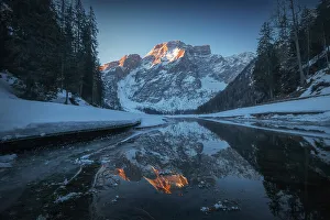 A cold winter sunrise along the frozen shores of the Braies lake (Pragser Wildsee). Dolomites, Italy Adventure Gallery: A cold winter sunrise along the frozen shores of the Braies lake (Pragser Wildsee). Dolomites, Italy