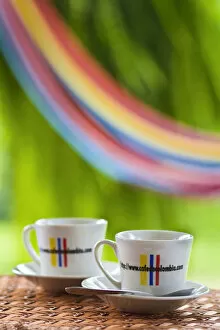 Images Dated 11th January 2010: Colombia, Caldas, Manizales, Hacienda Venecia, Coffee cups on table with hammock in