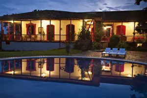 Colombia, Caldas, Manizales, Hacienda Venecia reflecting in pool at night