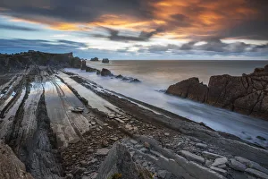 Low Tide Prints: Colorful clouds during sunset at Playa de la Arnia, Boo de Pielagos, Cantabria, Spain