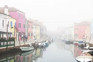 Couple Gallery: Colorful houses in Burano with canal and moored boats in the fog, Venice, Venetian lagoon