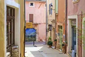 Ochre Prints: Colorful ochre colored buildings on a street in Roussillon