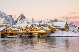 Images Dated 4th July 2016: The colors of dawn frames the fishermen houses surrounded by snowy peaks Sakrisoy