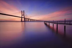 The colors of dawn on Vasco da Gama Bridge that spans the Tagus River in Parque