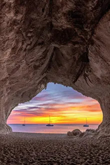 Vertical Prints: Colors of the sunrise inside the sea cave on the beach of Cala Luna