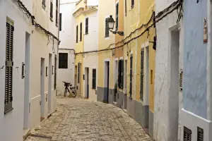 Narrow Prints: Colourful buildings line a narrow street in the old town of Ciutadella, Ciudadela