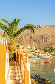 The colourful harbour and Saint Nicholas church in the background, Halki, Chalki, Dodecanese Islands, Greece