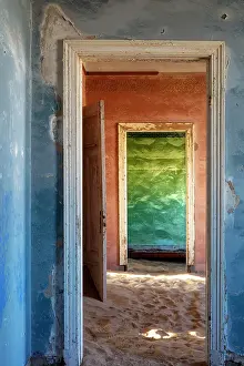 Abandoned Prints: Colourful painted rooms with floors covered in sand in abandoned diamond mining town