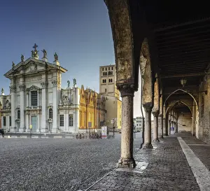 Colored Prints: Columuns and arches of the Ducal Palace in Sordello Square with mantua cathedral in background after sunset Mantova