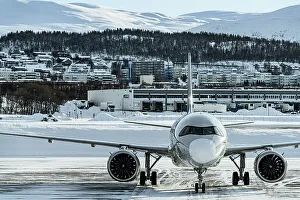 Nordland County Prints: Commercial aircraft in the frozen airport of Tromso in winter, Norway