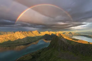 Adventure Gallery: A complete rainbow above the fjords of Senja Island on a rainy summer evening. Norway