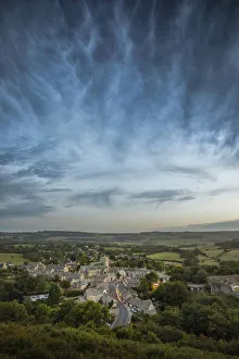 Corfe Castle village with storm clouds above viewed from East Hill, Dorset, England, UK Corfe Castle village with storm clouds above viewed from East Hill, Dorset, England, UK