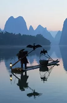 Images Dated 20th October 2015: Cormorant fisherman on Li River at dawn, Xingping, Yangshuo, Guangxi, China