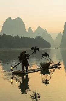 Images Dated 20th October 2015: Cormorant fisherman on Li River at dawn, Xingping, Yangshuo, Guangxi, China