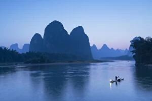 Guangxi Province Gallery: Cormorant fisherman on Li River at dusk, Xingping, Yangshuo, Guangxi, China