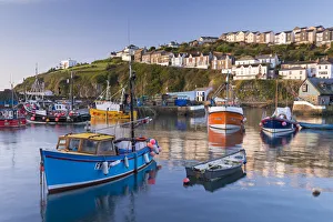 Cornish fishing boats in Mevagissey harbour at sunrise, Cornwall, England. Spring
