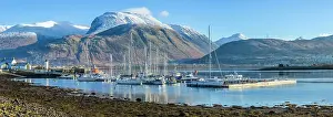Hillside Prints: Corpach lighthouse and marina on the shores of Loch Eli with snow capped Ben Nevis and Fort William