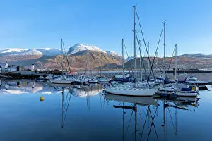 Hillside Prints: Corpach lighthouse and marina on the shores of Loch Eli with snow capped Ben Nevis and Fort William