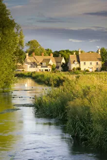 Cottages near the River Coln at Fairford in the Cotswolds, Gloucestershire, England