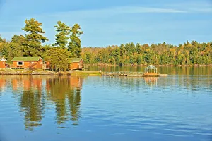 Cottages reflected in Lake of the Woods Sioux Narrows, Ontario, Canada