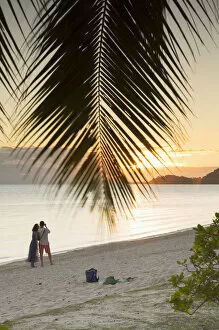 Couple on Matira Beach at sunset, Bora Bora, Society Islands, French Polynesia