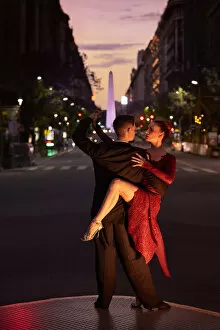 Performing Collection: A couple of Professional Tango dancers with the Obelisk monument in background at twilight