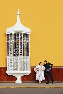 A couple of traditional Marinera'dancers in front of a colonial architecture window of the Plaza de Armas'in Trujillo, La Libertad, Peru. Marinera is the Peruvian National dance. (MR)