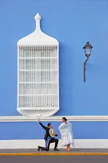A couple of traditional Marinera'dancers in front of a colonial architecture window of the Plaza de Armas'in Trujillo, La Libertad, Peru. Marinera is the Peruvian National dance. (MR)
