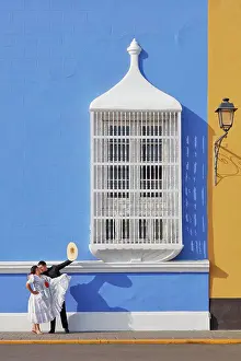 Dance Prints: A couple of traditional Marinera'dancers in front of a colonial style window of the Plaza de Armas'in Trujillo
