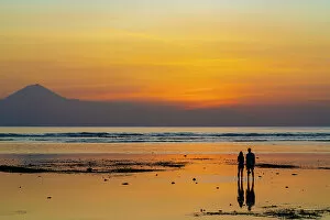 Images Dated 28th February 2023: Couple watching sunset on low tide, Gili Trawangan, Lombok, Indonesia