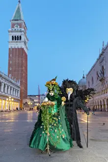 2018 Prints: A couple wearing masks and Venetian costume stand in St Marks square during