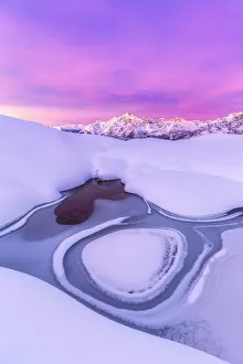 Cold Gallery: Crazy shape in a frozen alpine lake at sunrise with view on Mount Disgrazia
