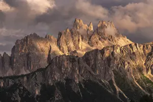Rain Prints: Croda da Lago getting the last light of the day after a storm with a fain rainbow