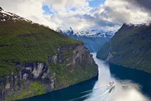A Cruise Ship navigates through a bend in the dramatic Geiranger Fjord, Geiranger