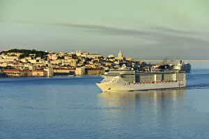 A cruise ship in the Tagus river. The historic centre of Lisbon in the background