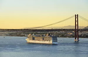 Images Dated 2nd December 2016: A cruise ship in the Tagus river, leaving the port of Lisbon, passes beneath the 25