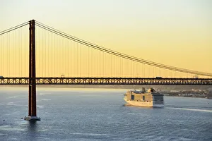 Images Dated 2nd December 2016: A cruise ship in the Tagus river, leaving the port of Lisbon, passes beneath the 25