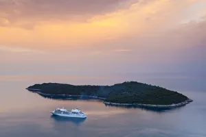 Former Yugoslavia Prints: Cruiseboat and island illuminated at sunrise, Dubrovnik, Dalmatia, Croatia