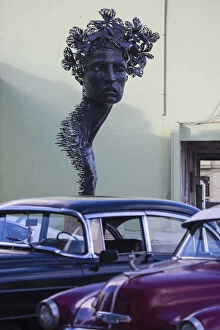 Republic Gallery: Cuba, Havana, The Malecon, Classic America cars infront of statue