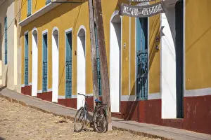 Cobbled Street Prints: Cuba, Trinidad, Bike leaning against lamp post by colourful houses
