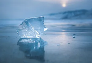 Desolation Prints: A cube of ice on the flat frosen lake at sunset, Baikal, Irkutsk region, Siberia, Russia