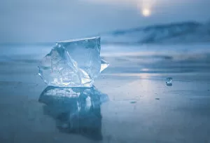 A cube of ice on the flat frosen lake at sunset, Baikal, Irkutsk region, Siberia, Russia