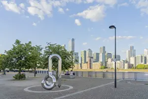 Curlicue sculpture by William Pye and Canary Wharf and the River Thames, London, England