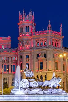 Marble Gallery: Cybele Palace or Palacio de Cibeles city hall illuminated by colors of Spanish flag
