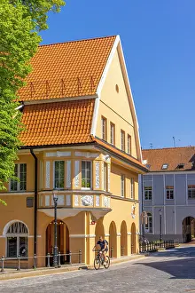 Cyclists Prints: Cyclist infront of Traditional Buildings, Klaipeda, Lithuania