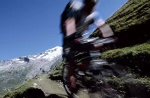 Action Sport Gallery: A cyclist mountain biking on Mont Blanc