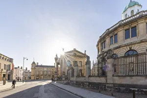 Oxfordshire Prints: Cyclist beside the Sheldonian Theatre, Oxford, Oxfordshire, England, UK